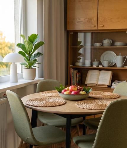a dining room table with a bowl of fruit on it at PAE korter Kärdlas in Kärdla