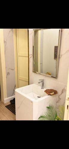 a bathroom with a white sink and a mirror at Ksa3 in Hail