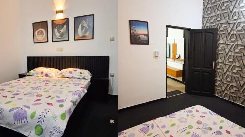 a bedroom with a bed and a door to a bathroom at Cotonou AMAZONE GUEST in Cotonou