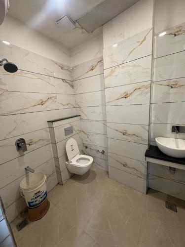 a bathroom with a toilet and a sink at Hotel U V 2 mins from golden temple in Amritsar