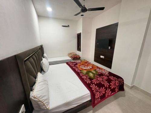 a bedroom with a bed with a red blanket at Hotel U V 2 mins from golden temple in Amritsar