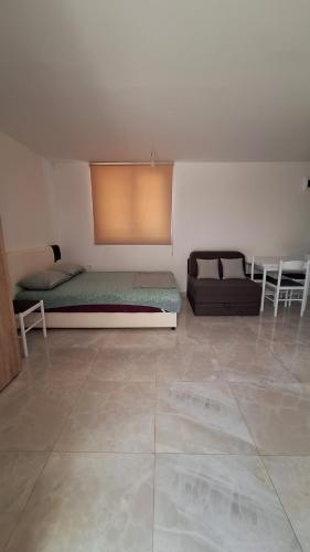 a room with two beds and a couch and a table at Coco 2 free parking in Pržno