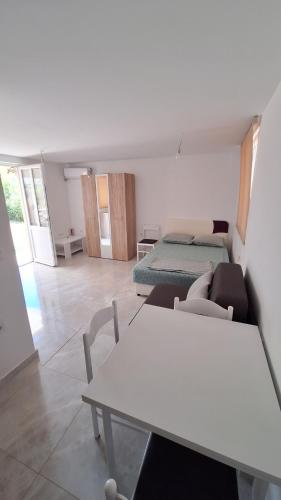 a living room with a white table and chairs at Coco 2 free parking in Pržno