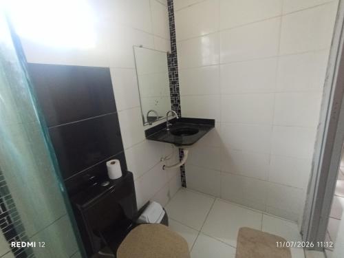 a small bathroom with a sink and a toilet at kit Net no Vinhais in São Luís