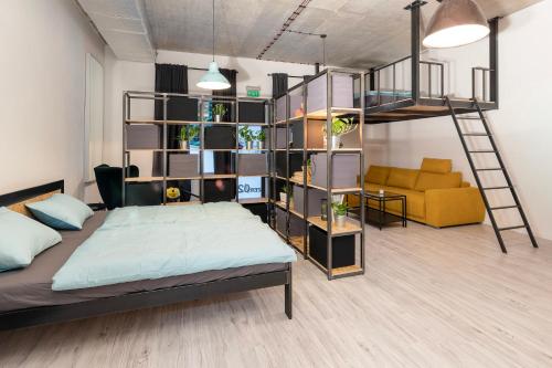 a bedroom with a bed and a book shelf at Industrial Apartment ZERO in Bratislava
