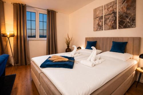 a bedroom with a large bed with towels on it at Schängel Chic 19 in Koblenz