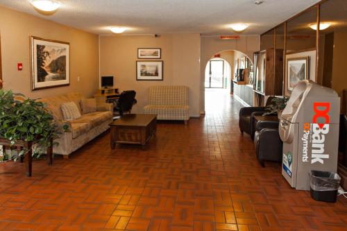 a living room with a couch and a table at Haida Way Motor Inn in Port McNeill