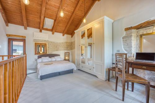 a bedroom with a bed and a desk at Holiday House Ante in Žminj