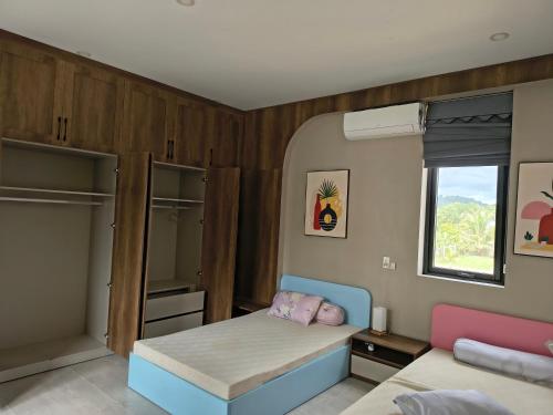 a small bedroom with a bed and a window at LaiKa in Phú Quốc