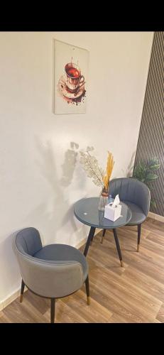 a table and two chairs in a room with a table at Ksa2 in Hail