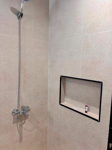 a shower with a glass door in a bathroom at ايراد للشقق المفروشه in Dammam