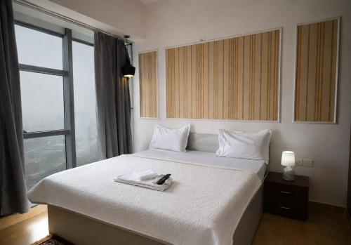 a hotel room with a bed with a tray on it at Sofitel Caravanserai 1BHK Noida, Spectrum Mall Sector 75 in Noida