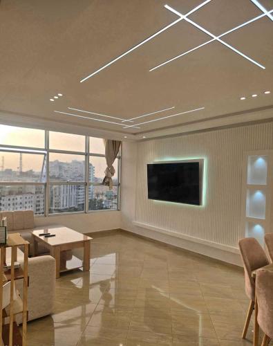 a living room with a tv and a couch and a table at panoramic sky 17 in Tangier