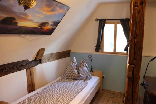 a bedroom with a bed and a window at Ferienhaus Elsa mit Sauna und Whirlpool in Großschönau