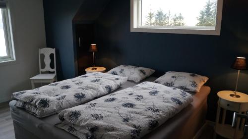 a bedroom with two beds with pillows and a window at Kvalheim Nordfjord in Myre