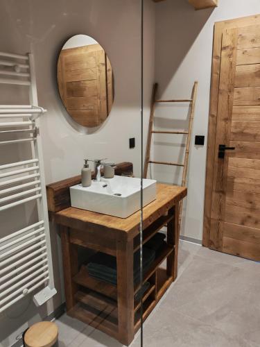 a bathroom with a sink and a mirror at Le BÔ Chalet - Jacuzzi et Sauna - 3 chambres in Anould
