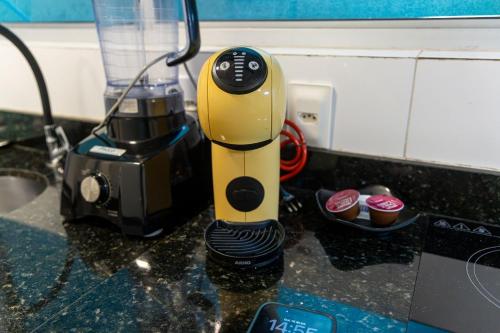 a yellow blender sitting on top of a counter at Apartamentos com internet rápida in Maceió