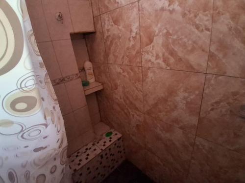 a small bathroom with a shower and a toilet at Casa Chicho in Santiago del Estero
