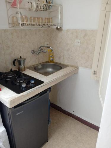a kitchen with a sink and a stove at Maison Traditionnelle in Casablanca