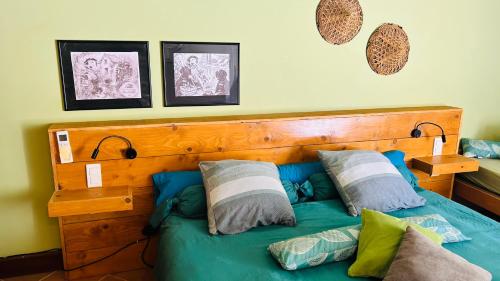 a bedroom with a blue bed with pillows on it at Chambres d'hôtes MoulinDT in Virazeil
