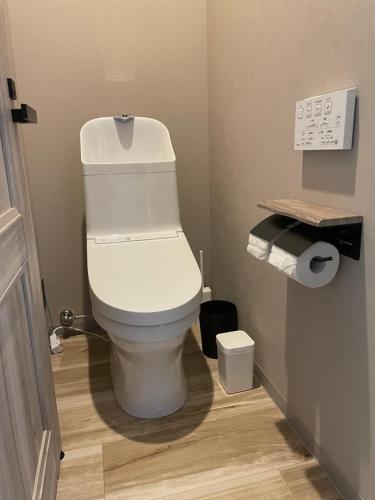 a bathroom with a white toilet in a room at Cafe&Stay Stella in Minakami