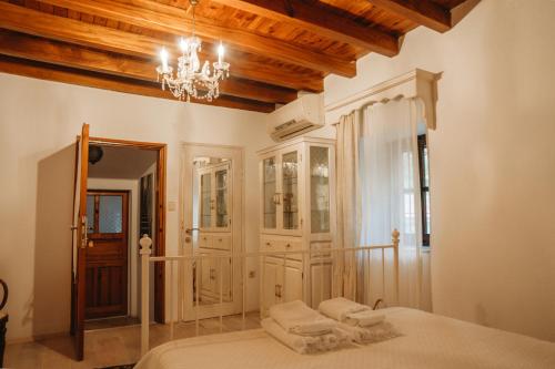 a bedroom with a bed and a chandelier at Boleka Bodrum in Bodrum City