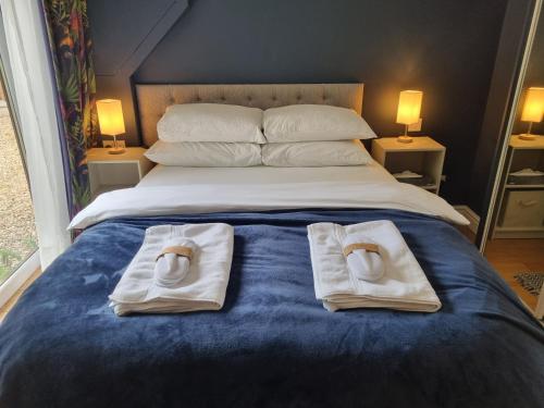 a bedroom with a bed with towels on it at A quiet gem just outside Oundle in Oundle