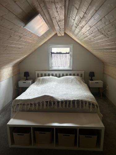 a bedroom with a large bed with two night stands at Domek se zahrádkou in Zbečno