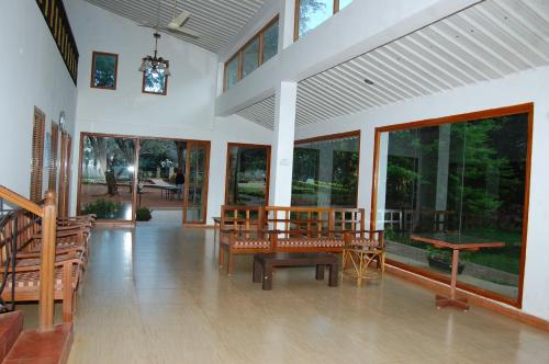 a room with benches and tables in a building at Zeenath Taj Gardens in Yelagiri