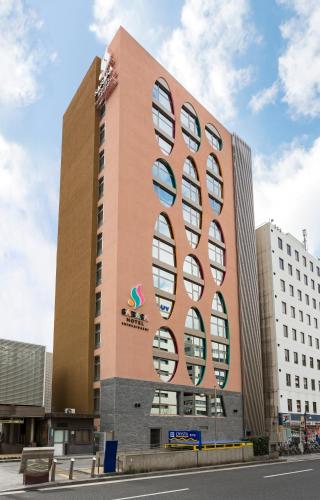 a large building with a lot of windows on it at SARASA HOTEL Shinsaibashi in Osaka