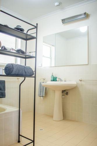 a bathroom with a sink and a mirror at Beachfront Getaway Pet-Friendly & Near Boat Ramp - Koala Stay in Encounter Bay