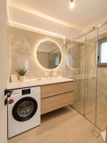 a bathroom with a washing machine and a shower at Luxury Family Villa near beach in Lechaio