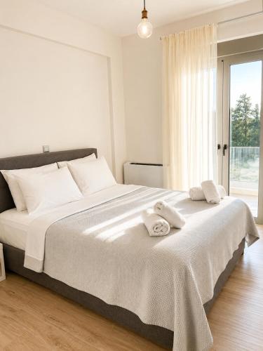 a bedroom with a large bed with towels on it at Luxury Family Villa near beach in Lechaio