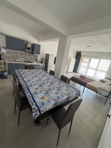 a dining room with a table and chairs and a kitchen at MC Rooms in Torretta