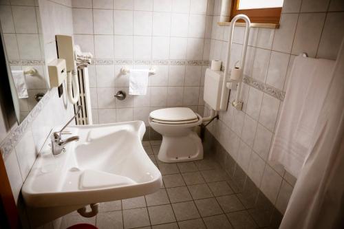 a white bathroom with a toilet and a sink at Hotel Giada in Turin