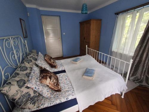 a bedroom with a bed with pillows on it at Hangvilla Vendégház in Miskolc