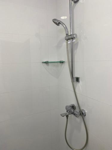 a shower with a shower head in a bathroom at Studio Apartment on a Terrace by Skysuites in Male City