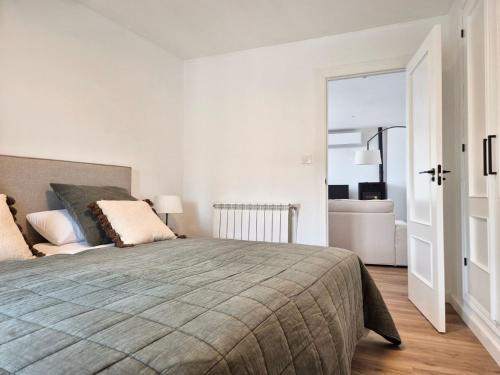 a bedroom with a large bed and a bathroom at YourHouse O Canton 3 in Lobios