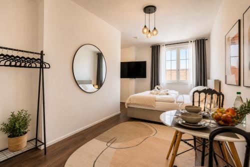 a living room with a table and a bed at Schängel Chic 27 in Koblenz