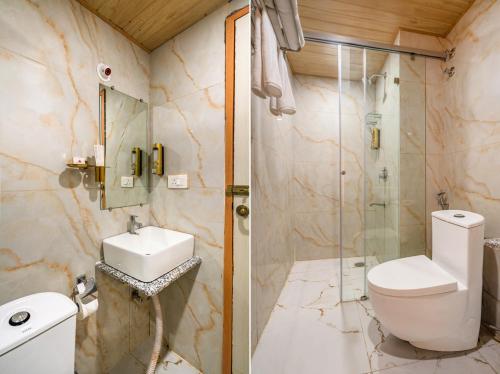 a bathroom with a toilet and a sink and a shower at Hotel Narenn HITEC CITY in Hyderabad