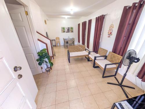 a hallway with chairs and a table in a room at Panglao 4 Bedroom Family and Group House With Pool in Dauis