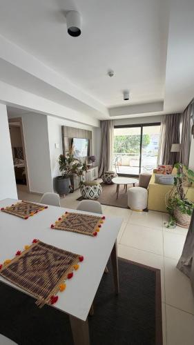a living room with a white table and a couch at Radisson blu résidence alhcoeima in Al Hoceïma