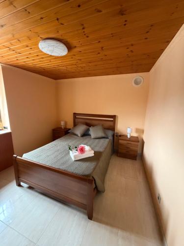 a bedroom with a bed with a wooden ceiling at Casa Gallopin in Foz