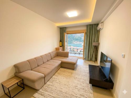a living room with a couch and a television at Belvedere in Dobrota