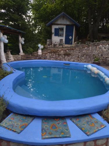 a large plunge pool in a yard with a house at Cabin 4 Hill Station in Sarajevo
