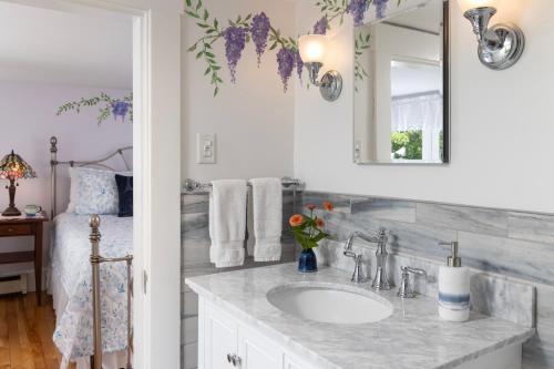 a bathroom with a sink and a mirror at Maguire House Bed and Breakfast in Ashburnham