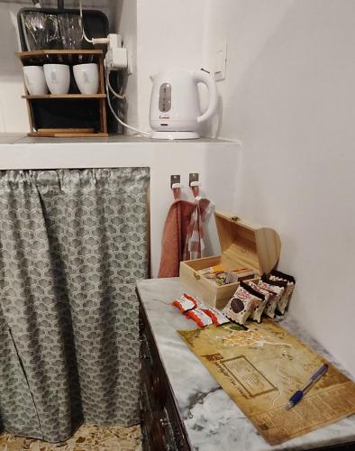 a kitchen with a counter with a box on it at El Rincón de la Magia in Soportújar
