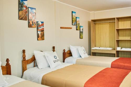 a hotel room with two beds and a window at QAIPU HOTEL in Puquio