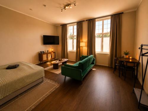 a bedroom with a bed and a couch and a chair at Schängel Chic 03 in Koblenz
