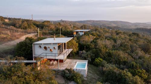 a house on a hill with a swimming pool at Villa Toscana I - Gran Vista y Tranquilidad in Villa Serrana
